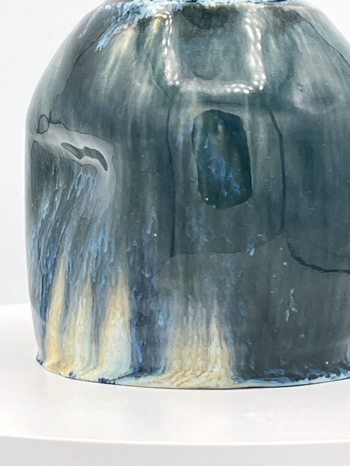 Ceramic oil decanter with blue and gray glaze on a white background