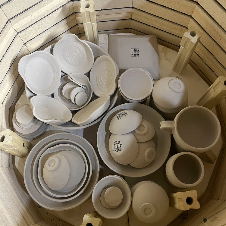 image shown from above, of bisque ware placed into an electric kiln