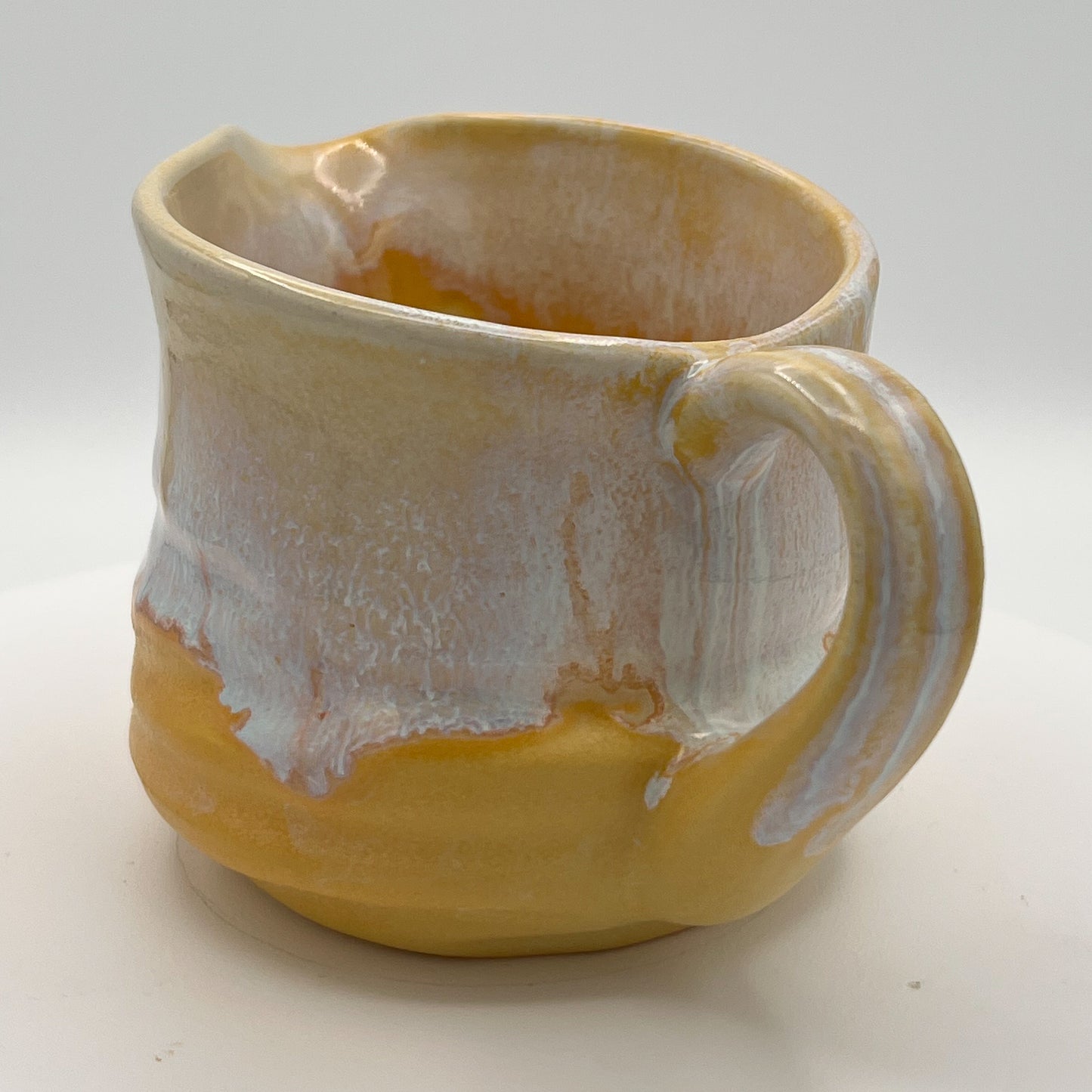 Ceramic mug with a unique glaze pattern on a white background