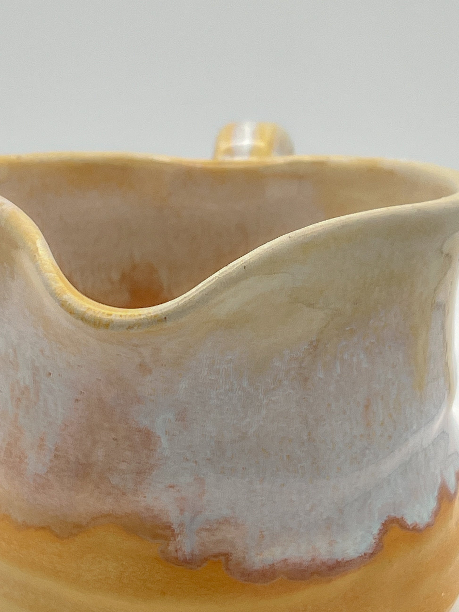 Close-up of a ceramic mug with a textured surface on a light background