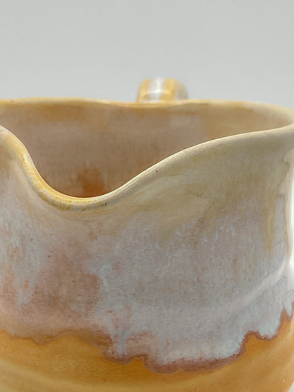 Close-up of a ceramic mug with a textured surface on a light background