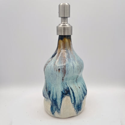 Handmade ceramic soap dispenser with blue and white flowing glaze and stainless steel pump