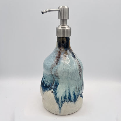 Handmade ceramic soap dispenser with blue and white flowing glaze and stainless steel pump