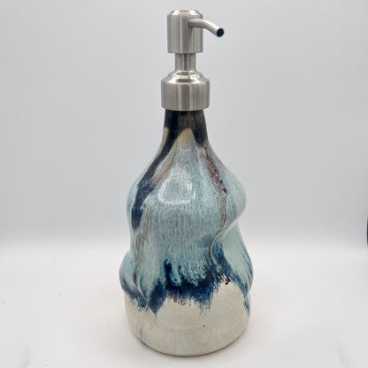Handmade ceramic soap dispenser with blue and white flowing glaze and stainless steel pump