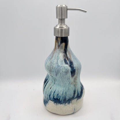 Handmade ceramic soap dispenser with blue and white flowing glaze and stainless steel pump