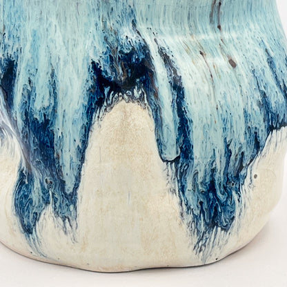Handmade ceramic soap dispenser with blue and white flowing glaze and stainless steel pump