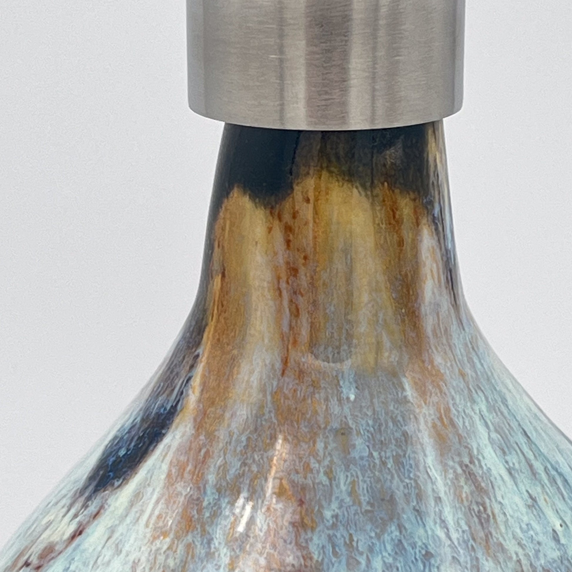 Handmade ceramic soap dispenser with blue and white flowing glaze and stainless steel pump