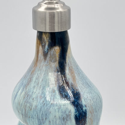 Handmade ceramic soap dispenser with blue and white flowing glaze and stainless steel pump