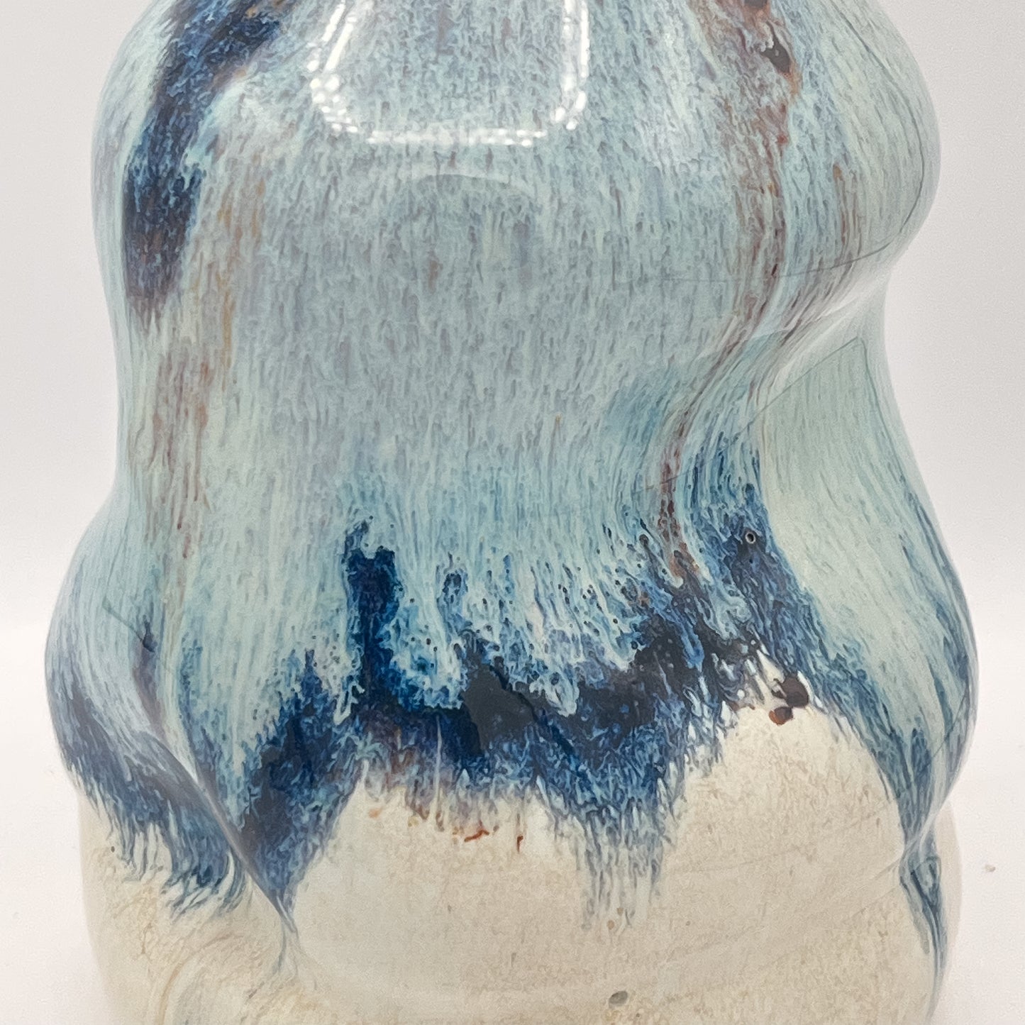 Handmade ceramic soap dispenser with blue and white flowing glaze and stainless steel pump