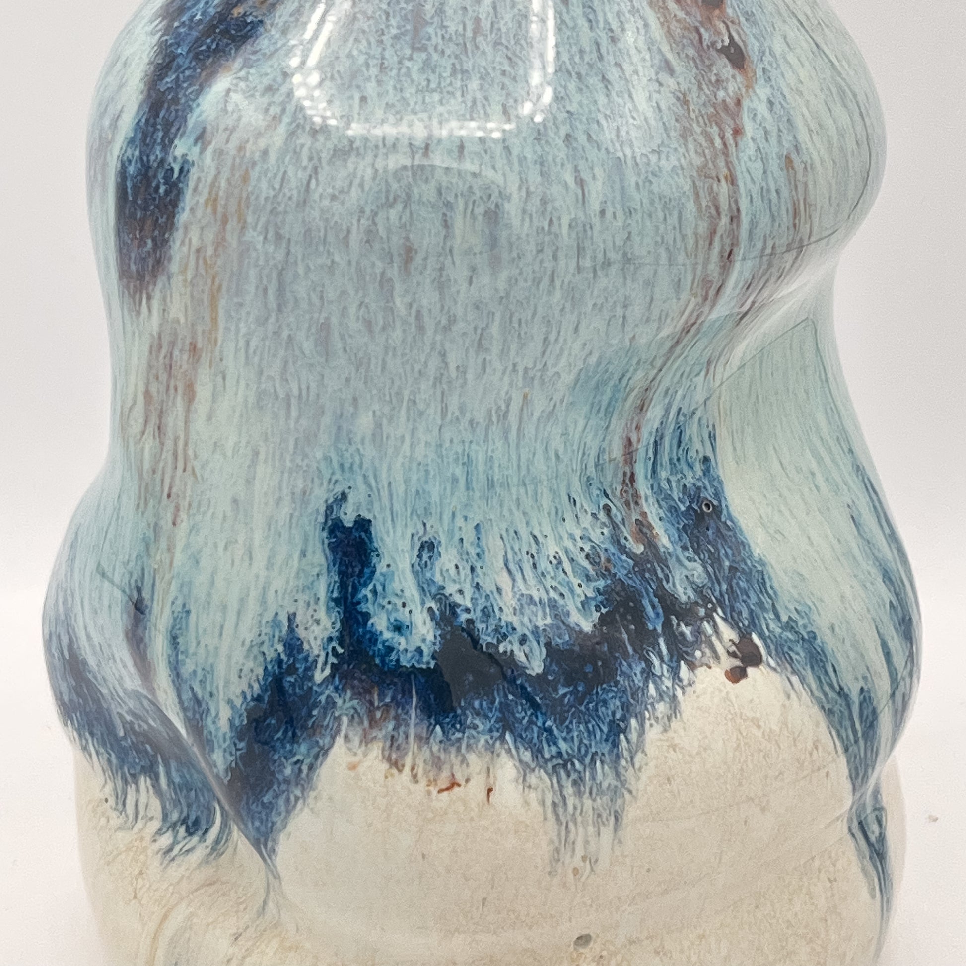 Handmade ceramic soap dispenser with blue and white flowing glaze and stainless steel pump