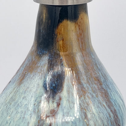Handmade ceramic soap dispenser with blue and white flowing glaze and stainless steel pump