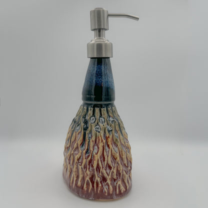 Ceramic soap dispenser with tree bark design on a gray background