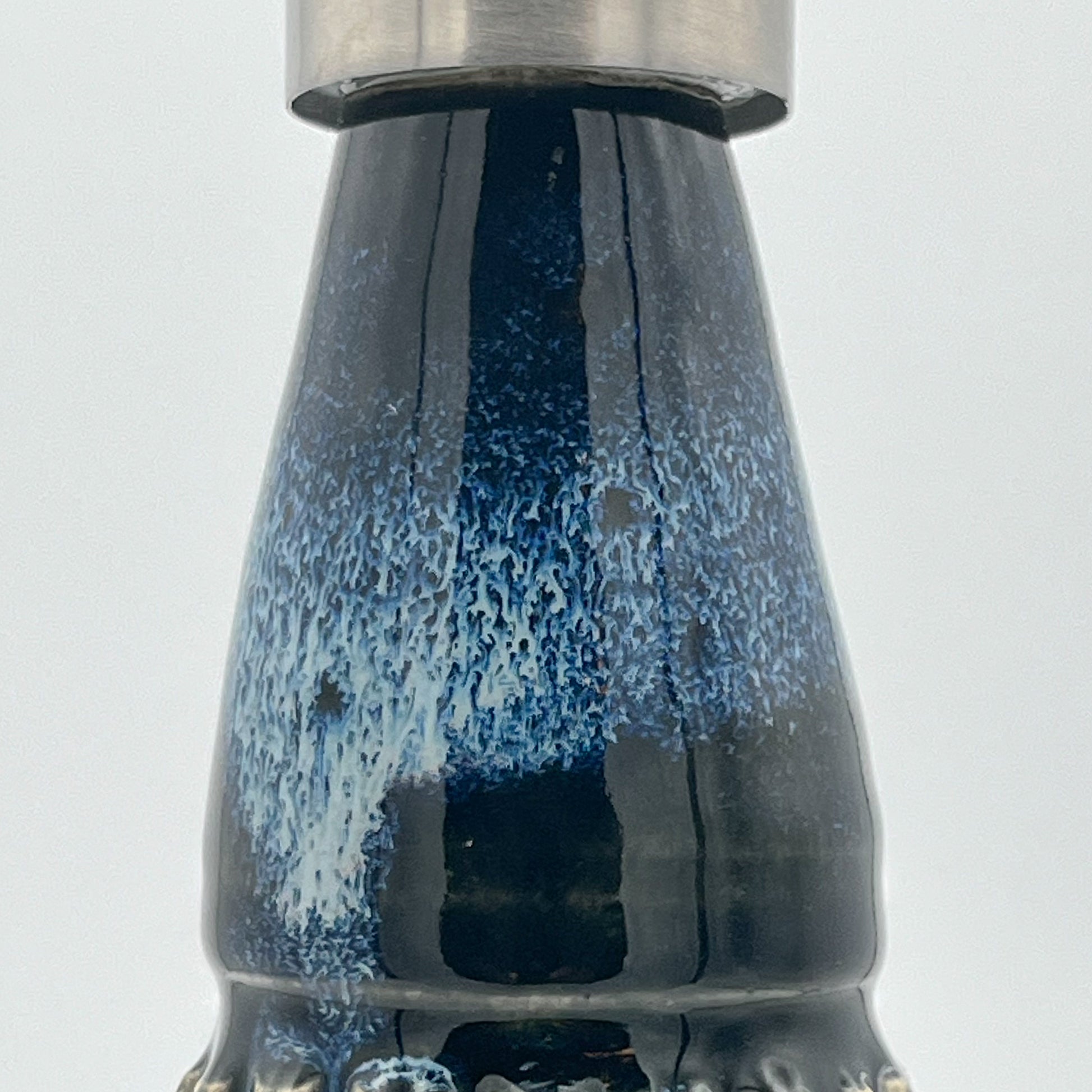 Detail with blue and white speckled pattern on a light gray background
