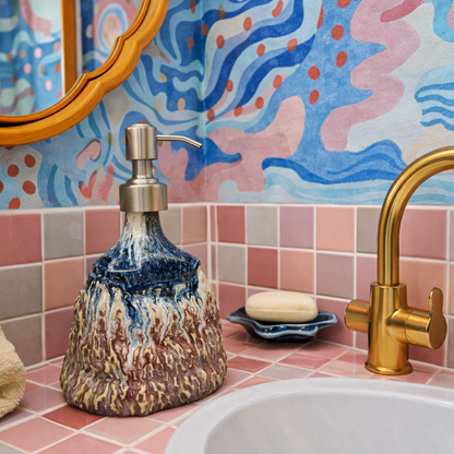 Decorative soap dispenser on a bathroom counter with colorful wall and tiles in the background