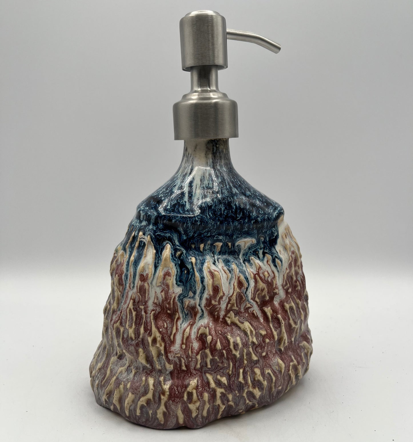 Soap dispenser with a natural stone design on a white background