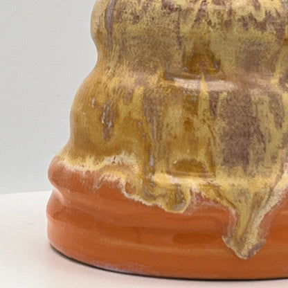 Close-up of a ceramic vase with a textured surface on a white background
