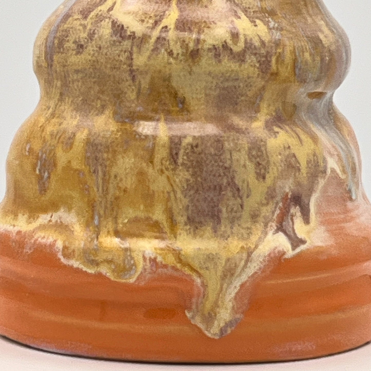 Close-up of a ceramic vase with textured surface and color variations.
