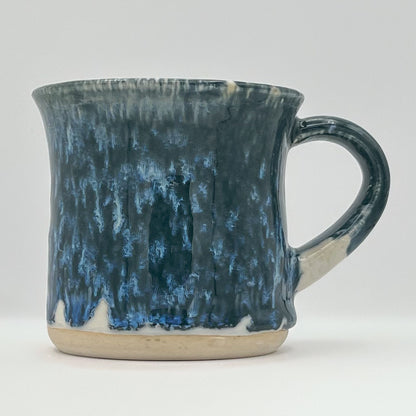 Blue and white ceramic mug on a light gray background