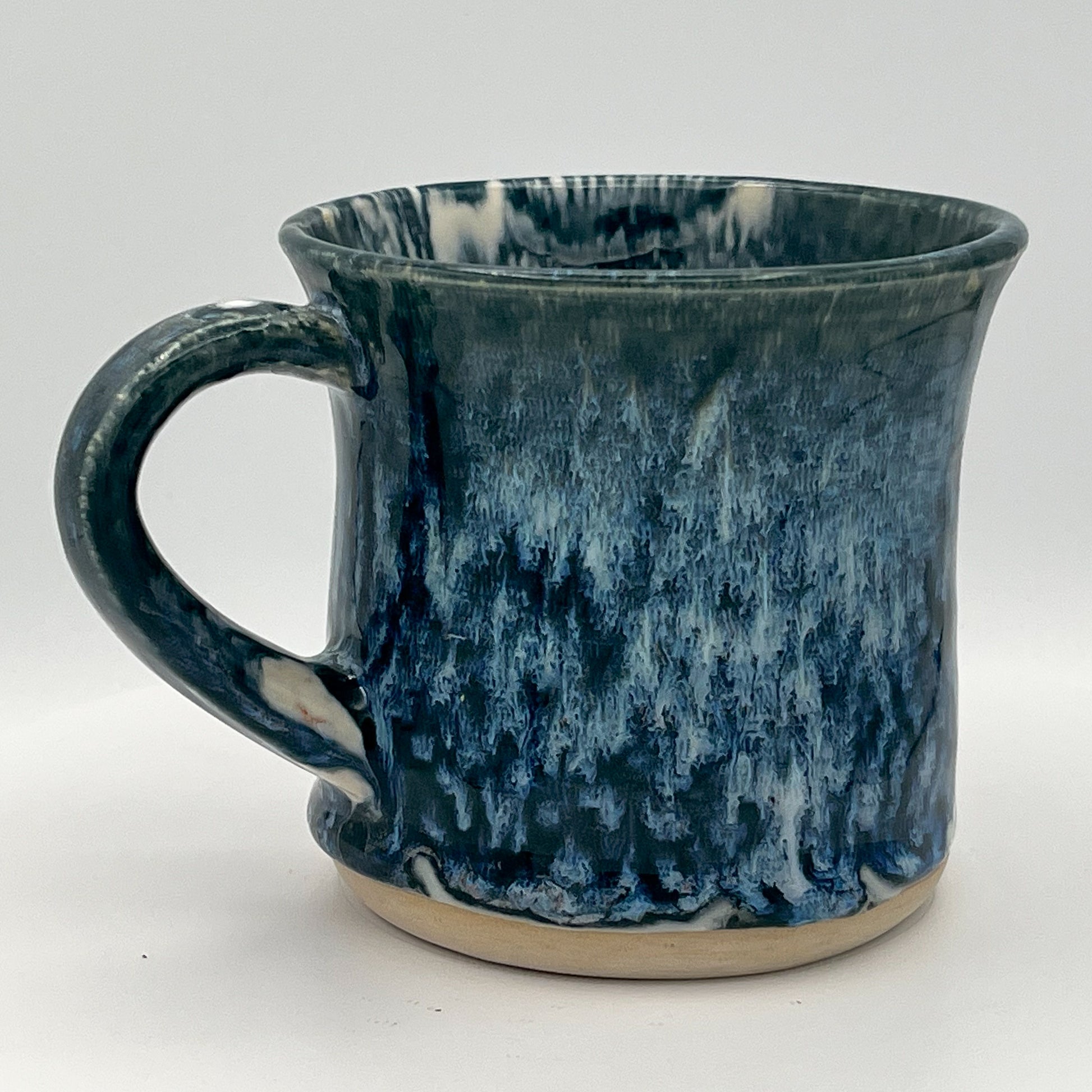 Blue ceramic mug with a textured surface on a white background