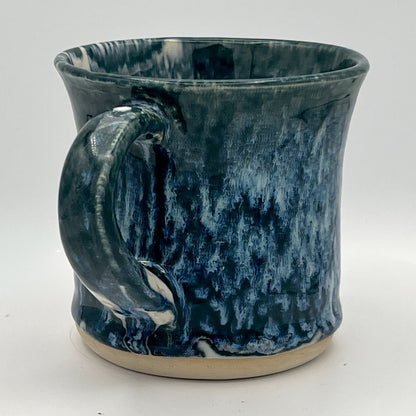 Blue ceramic mug with a textured surface on a white background
