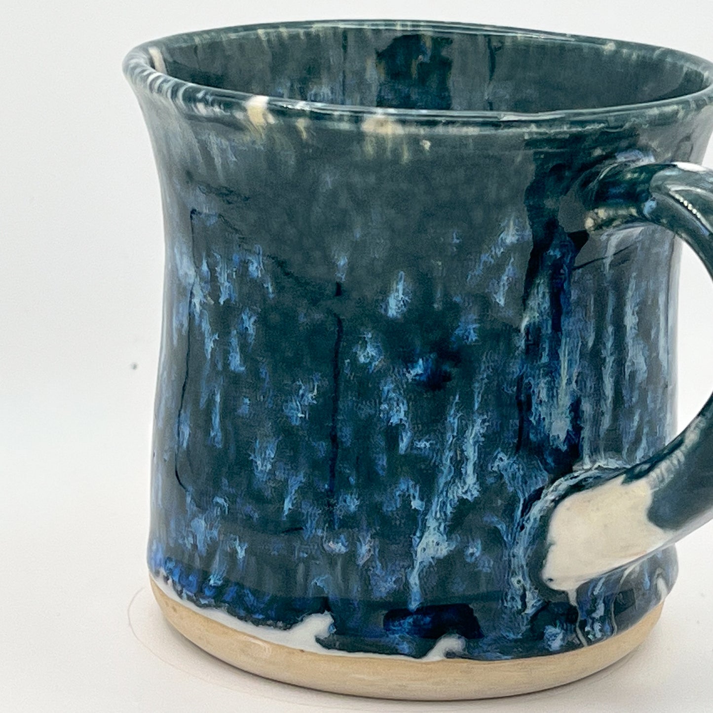 Blue ceramic mug with a textured surface on a white background