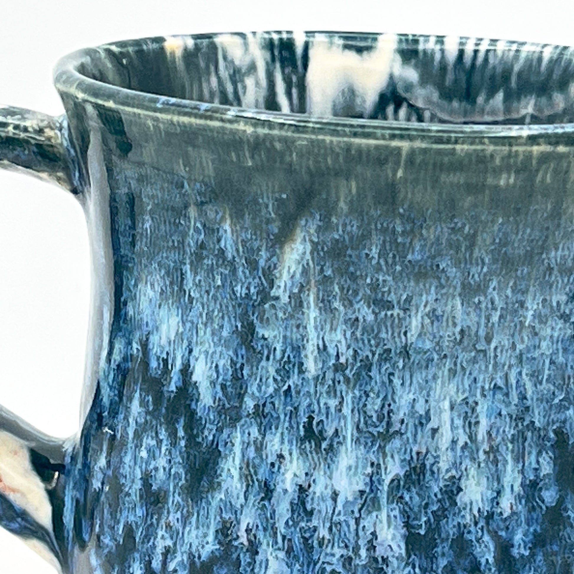 Close-up of a ceramic mug with blue and white glaze pattern