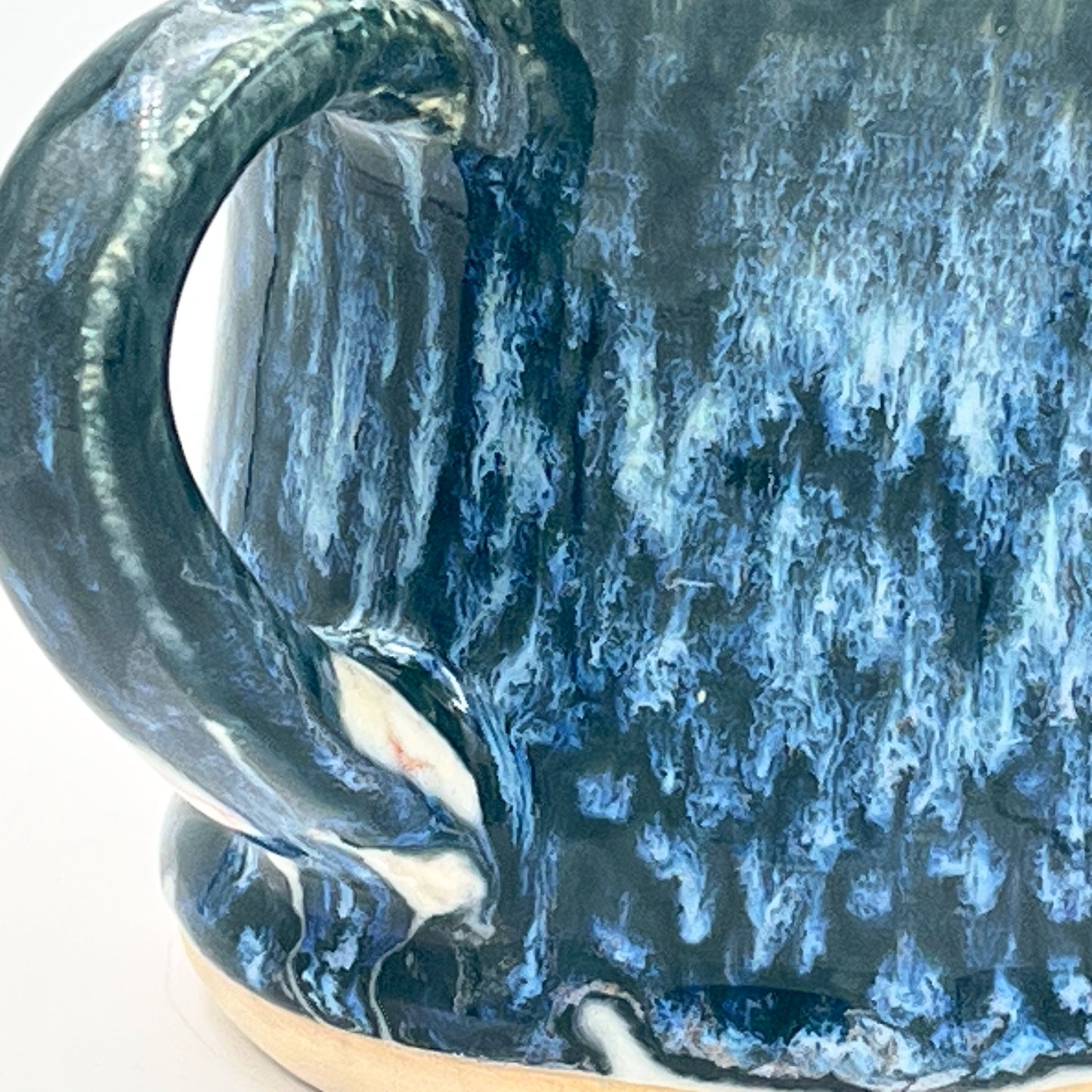 Close-up of a blue ceramic mug with a textured surface