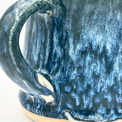Close-up of a blue ceramic mug with a textured surface