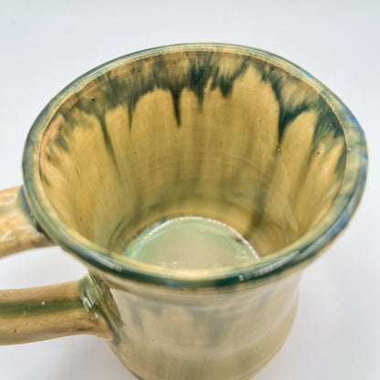 Handmade ceramic mug with moss green glaze and comfortable handle