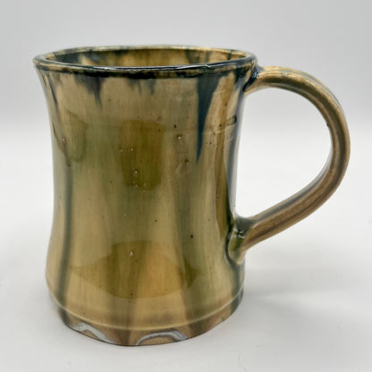 Handmade ceramic mug with moss green glaze and comfortable handle