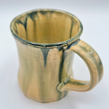 Handmade ceramic mug with moss green glaze and comfortable handle