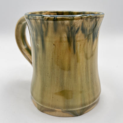 Handmade ceramic mug with moss green glaze and comfortable handle