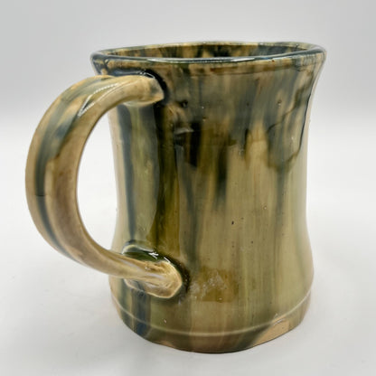 Handmade ceramic mug with moss green glaze and comfortable handle