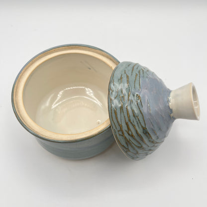 Handmade ceramic sugar bowl with blue and white glaze and textured lid