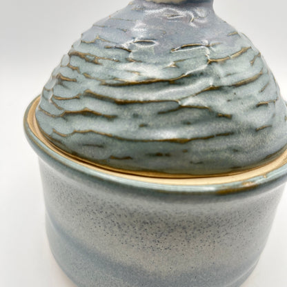 Handmade ceramic sugar bowl with blue and white glaze and textured lid
