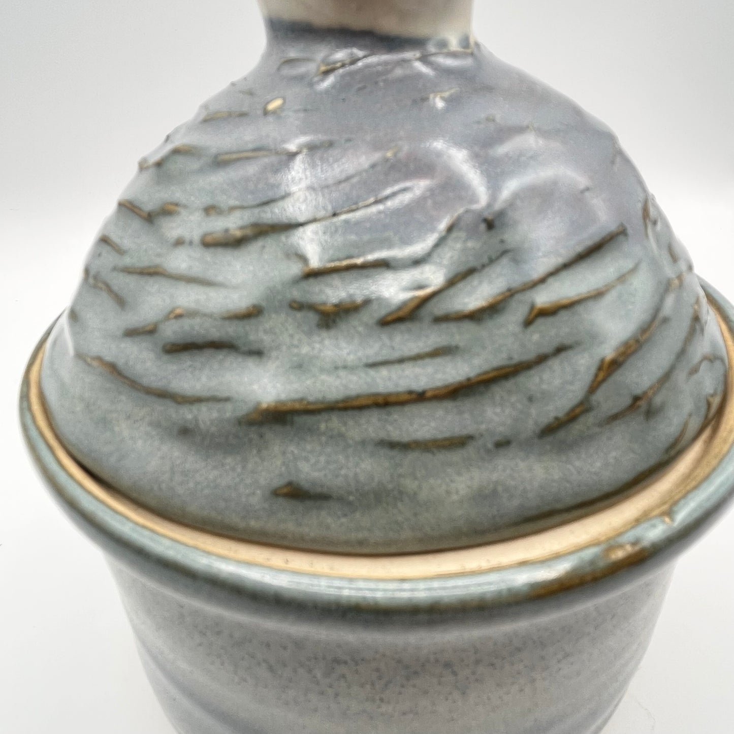 Handmade ceramic sugar bowl with blue and white glaze and textured lid
