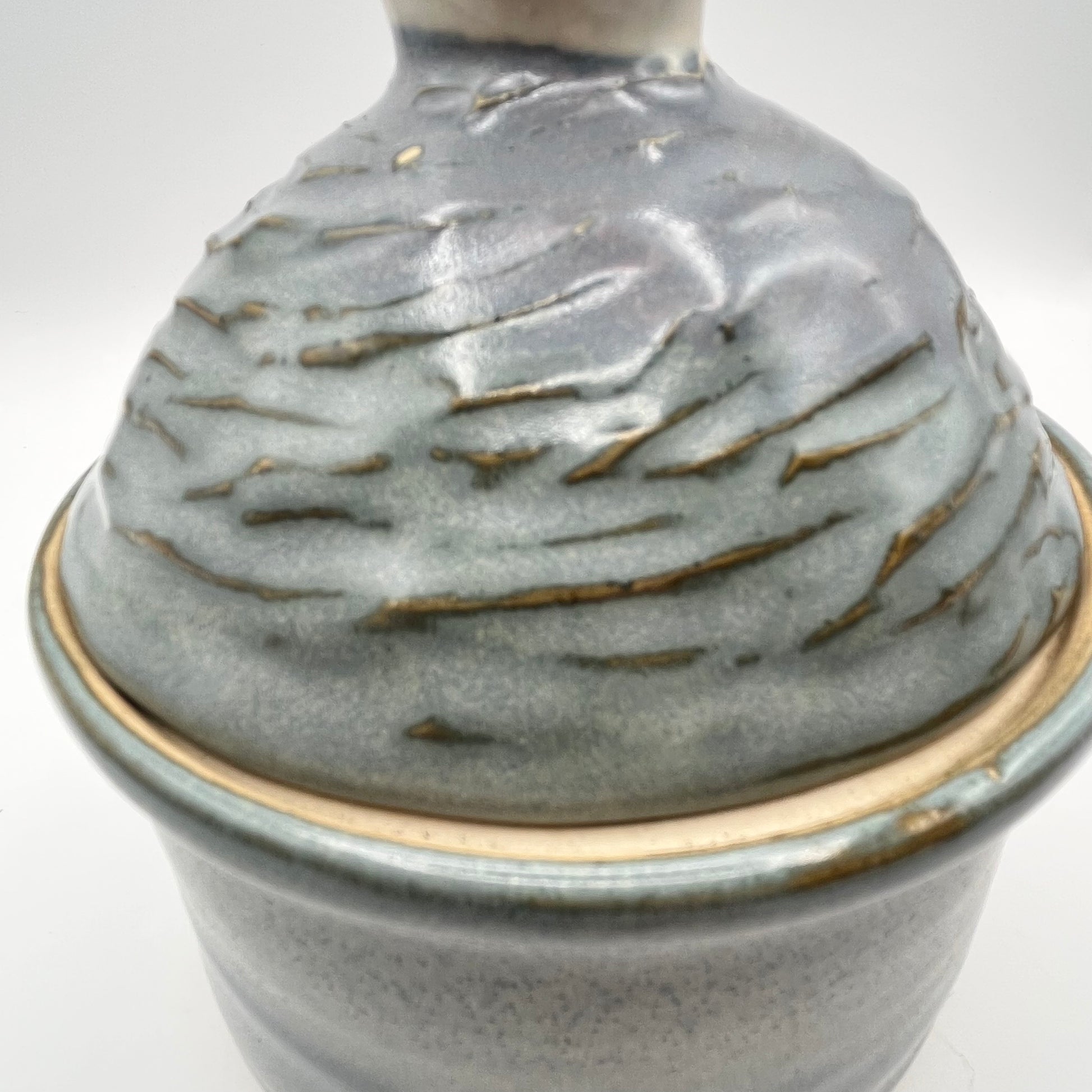 Handmade ceramic sugar bowl with blue and white glaze and textured lid