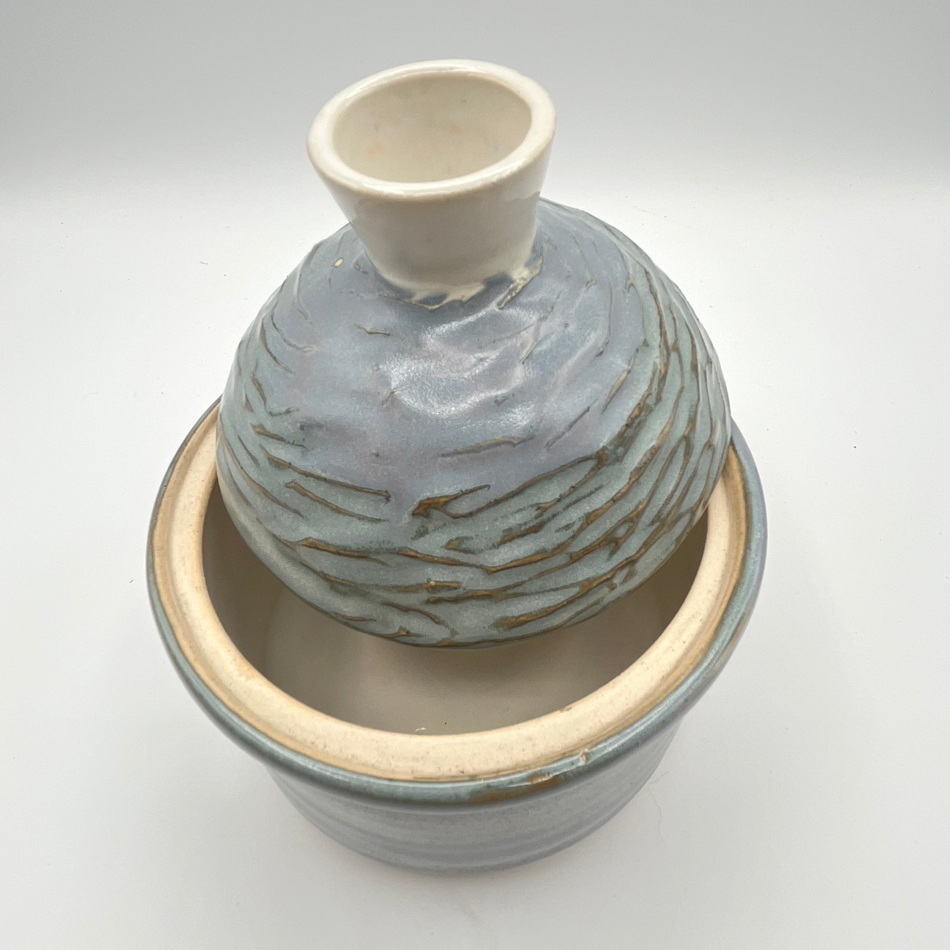 Handmade ceramic sugar bowl with blue and white glaze and textured lid