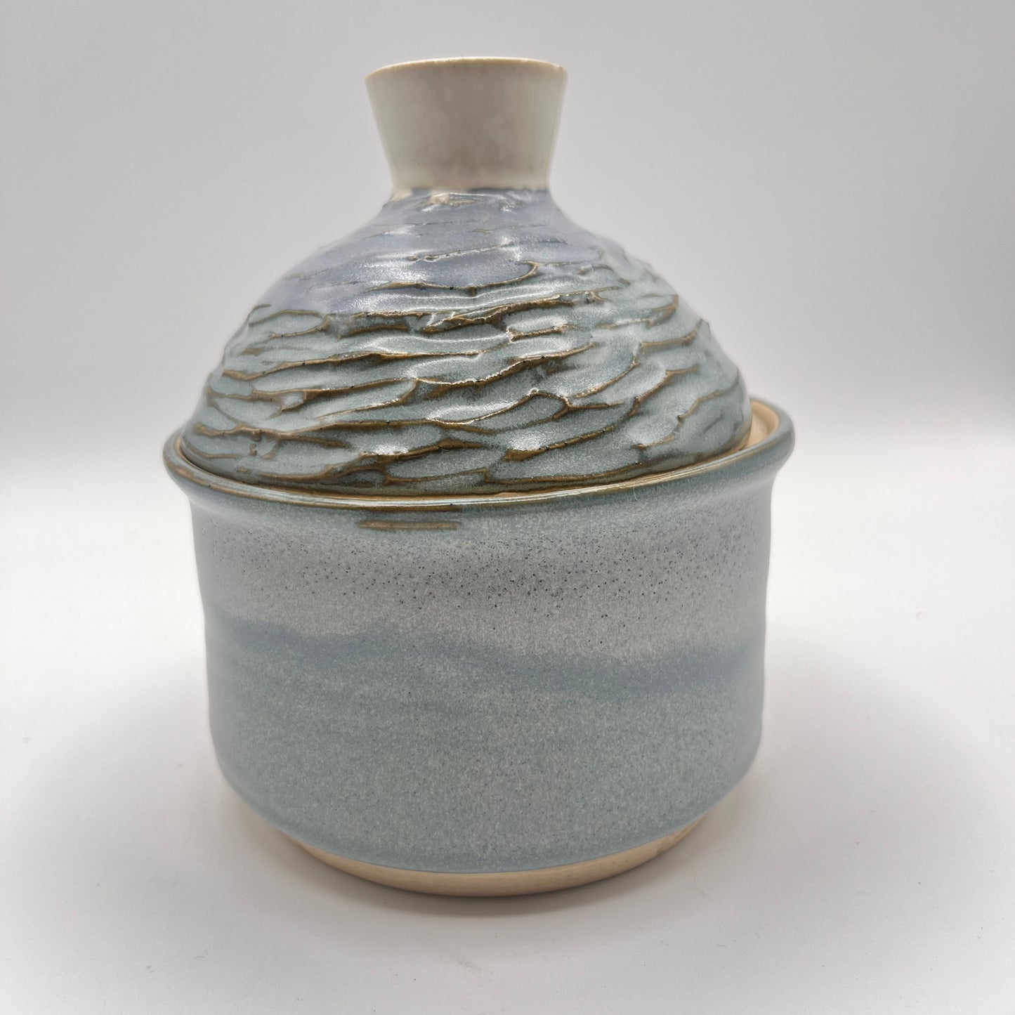 Handmade ceramic sugar bowl with blue and white glaze and textured lid