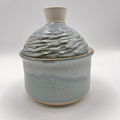 Handmade ceramic sugar bowl with blue and white glaze and textured lid