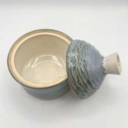 Handmade ceramic sugar bowl with blue and white glaze and textured lid