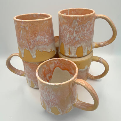 Handmade ceramic mug with peach and cream glaze and comfortable handle